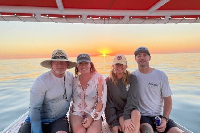 a couple of people that are sitting on a boat posing for the camera